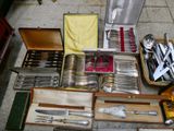 many different types of silverware in a box