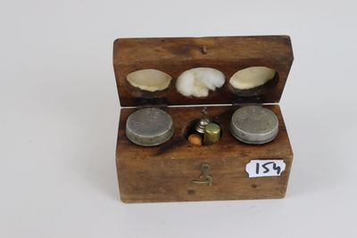 a small wooden box that has some coins inside of it