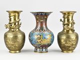 three vases sitting next to each other on a white surface