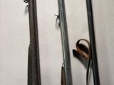 three old guns are lined up on a white surface