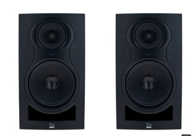 a pair of speakers sitting next to each other on a white surface