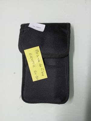 a black case with a yellow sticker on it sitting on a table