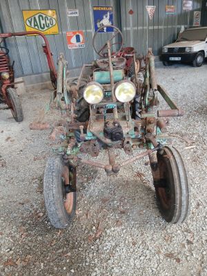 a old tractor that is sitting in a garage