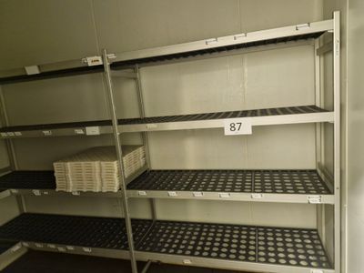 many shelves with baskets on them in a room
