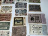several old german bank notes are displayed on a table