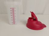 a plastic measuring cup and a plastic measuring cup on a table