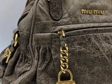 miu miu grey leather handbag with gold hardware and chain