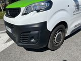 a white and green van parked on the side of the road