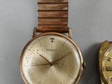 two watches sitting next to each other on a table