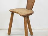 a wooden chair with a bent back and a bent seat