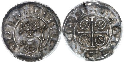 a close up of two silver coins on a white surface