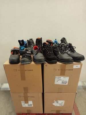 several pairs of shoes are stacked on top of boxes in a room