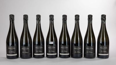 six bottles of wine are lined up in a row on a table
