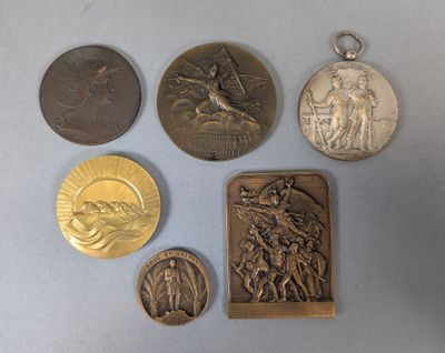 several medals and a medal on a table with a white background