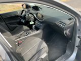 the interior of a car with the door open and a steering wheel in the passenger seat
