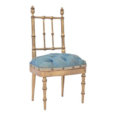 an image of a wooden chair with a blue cushion on top of it