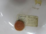 a small piece of paper on top of a white plate