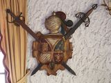 a picture of a wall mounted with two swords and a shield