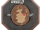 a picture of a wooden stop sign with a sticker on it