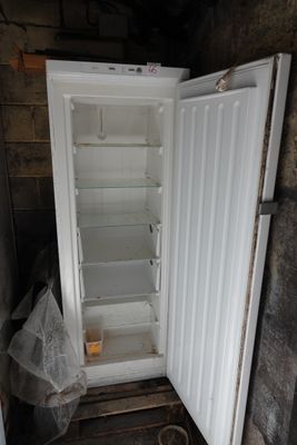 a white refrigerator with its door open in a room