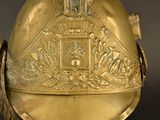 a gold helmet with a decorative design on it
