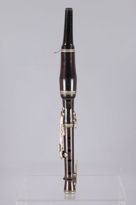 a close up of a bassoon on a clear acrylic stand