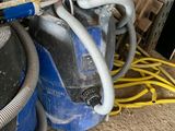 two blue tanks with hoses and a wren on them