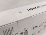 the back of a white box with a black and white logo on it