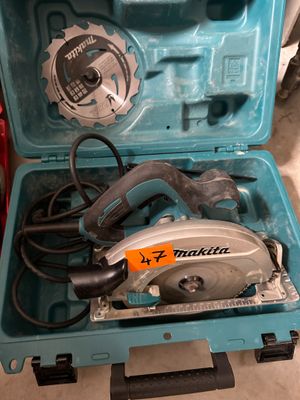 a blue tool case with a circular saw in it
