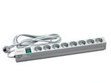 a close up of a white power strip with a green light on it