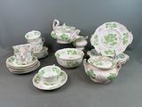 many plates and cups and saucers on the table