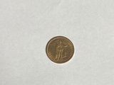 a close up of a small coin on a white surface