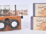 two boxes that have binoculars in them on a table