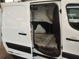 a white van with its doors open in a garage