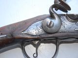 a close up of a gun on a white surface