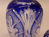 a blue glass vase and a small blue glass vase