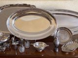 a table with a lot of silver items on it