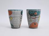 two cups that are sitting next to each other on a table