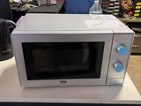 a white microwave sitting on top of a white counter