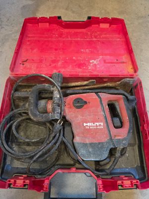 a red tool box with tools in it on the floor