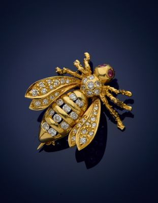 a gold and diamond bee broochle