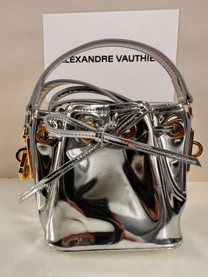 a silver purse that is sitting on a table