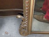 a mirror that is sitting on the floor in front of a door