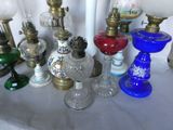 a lot of different glass lamps on a table