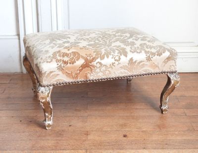 an image of a foot stool with a floral upholstered seat