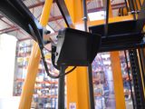 a yellow forklift with a monitor mounted to it ' s side