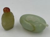 two green glass objects sitting next to each other on a white surface