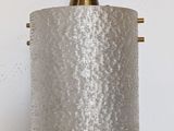 a close up of a lamp hanging on a wall