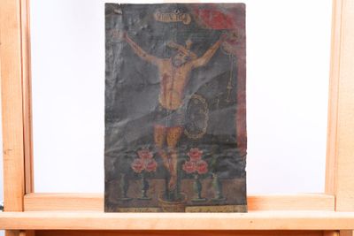 un tableau représentant un homme sur une croix, posé sur un chevalet