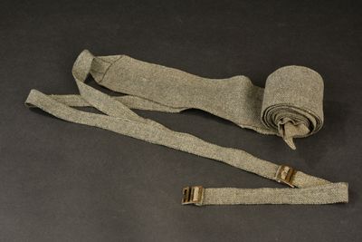 a roll of fabric with a metal buckle on it